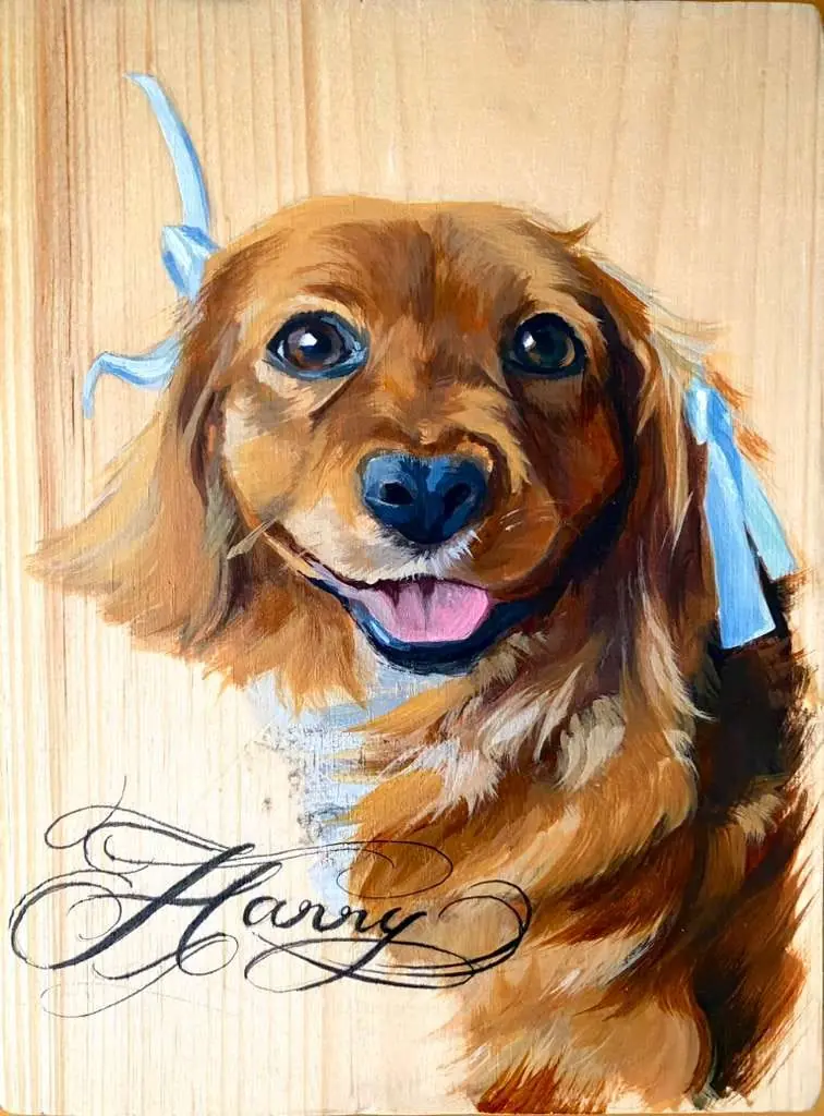 Painted portrait of a brown dog with blue ribbons